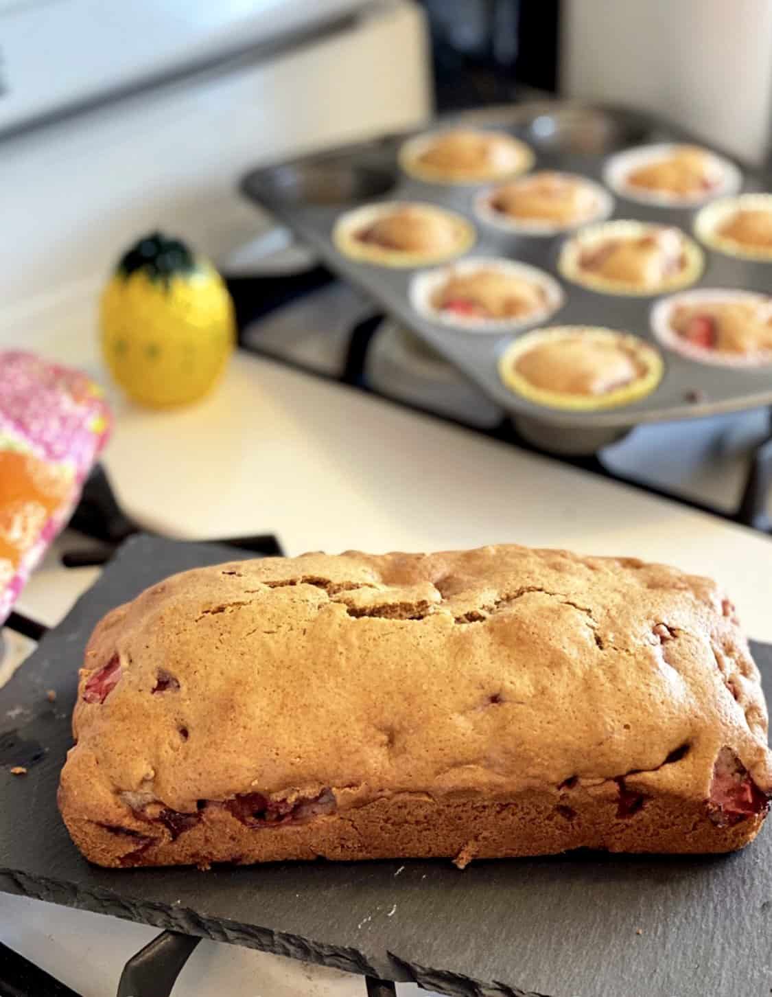 A sliced loaf of moist, easy strawberry bread made with fresh strawberries and pecans.