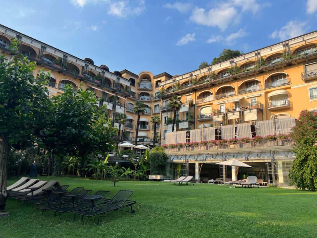 The historic yellow facade of the 5-star Grand Hotel Villa Castagnola in Lugano, Switzerland.