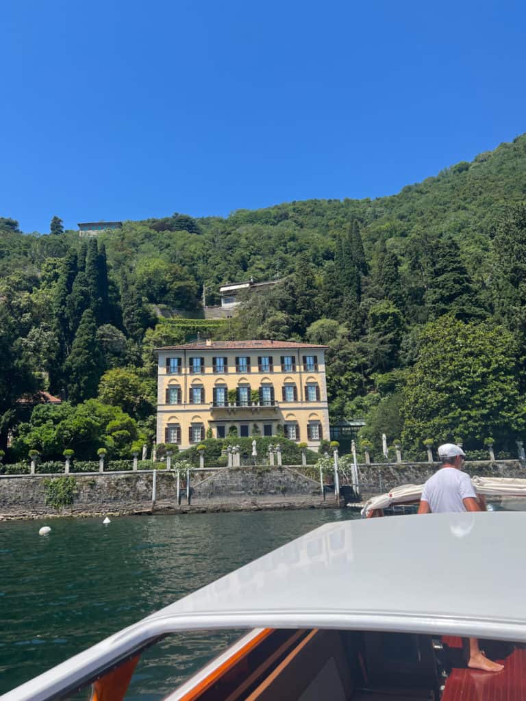 Beautiful historic luxury villas along the shoreline of Lake Como, seen from a private boat excursion.