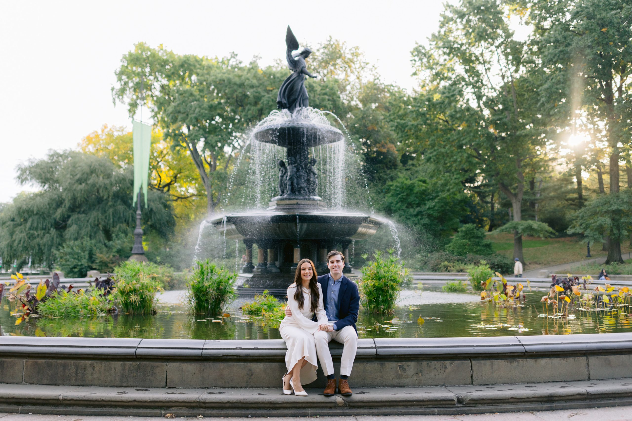 A relaxed moment sitting at Bethesda Terrace, showcasing the beautiful sandstone architecture of NYC during engagement shoot. 