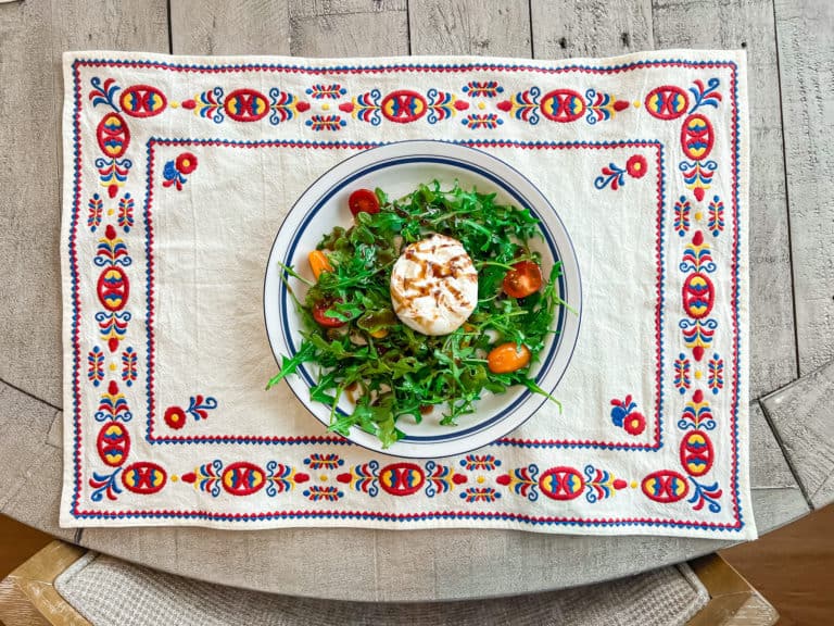 Burrata and arugula salad recipe plated nicely.