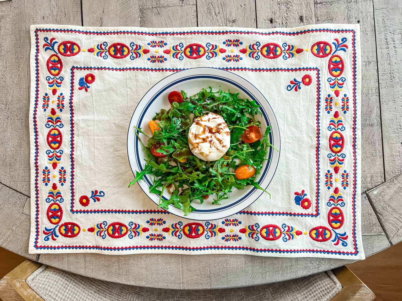 Burrata and arugula salad recipe plated nicely.