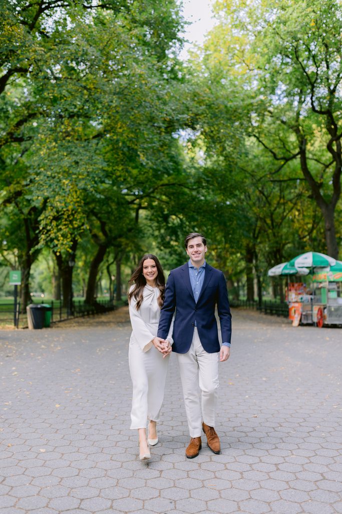 Ashley and her husband walking through the iconic tree-lined promenade of The Mall in Central Park.
