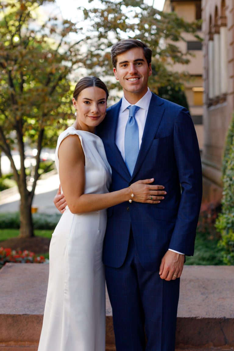 Ashley and her husband Drew on their wedding day, featuring the intentional wedding registry must haves they still use three years later.