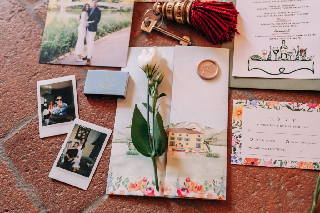 Cusom watercolor wedding invitations of. venue in Italy laid out on a table