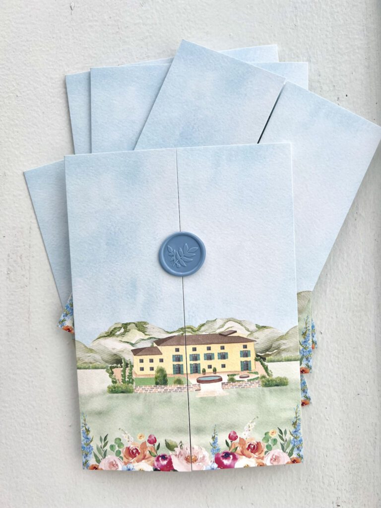 A full wedding invitation suite featuring a custom watercolor venue illustration of an Italian villa with elegant serif typography.