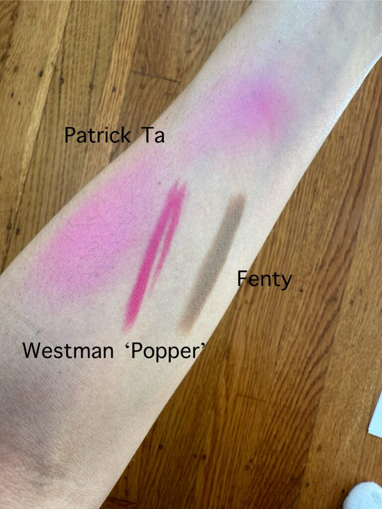 Wrist swatches on cool skin showing Fenty Amber contour, Patrick Ta She's Giving, and Westman Atelier Poppet blushes.