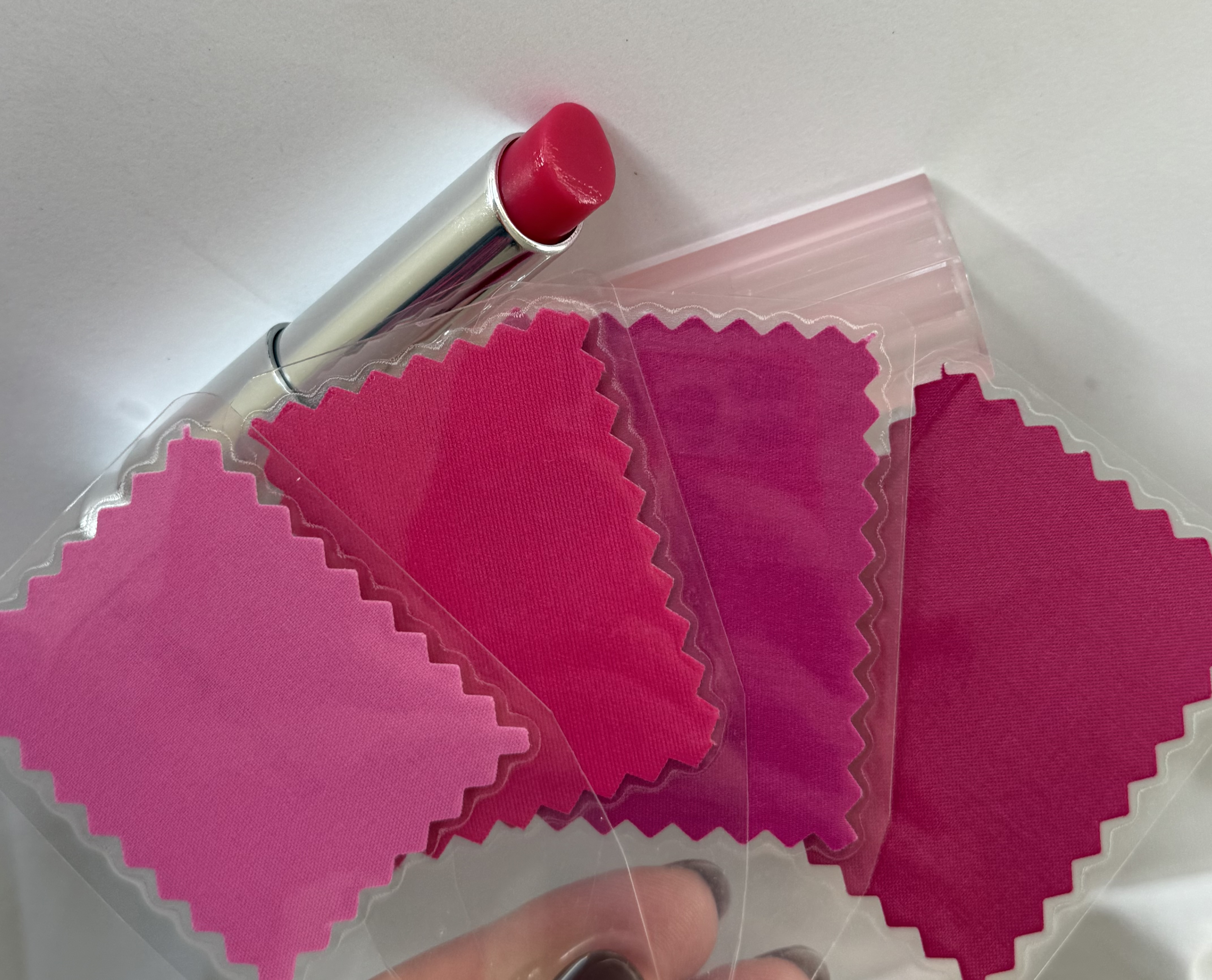 Dior Addict Lip Glow in Raspberry placed next to a True Winter color fan to show the cool-toned pink match.