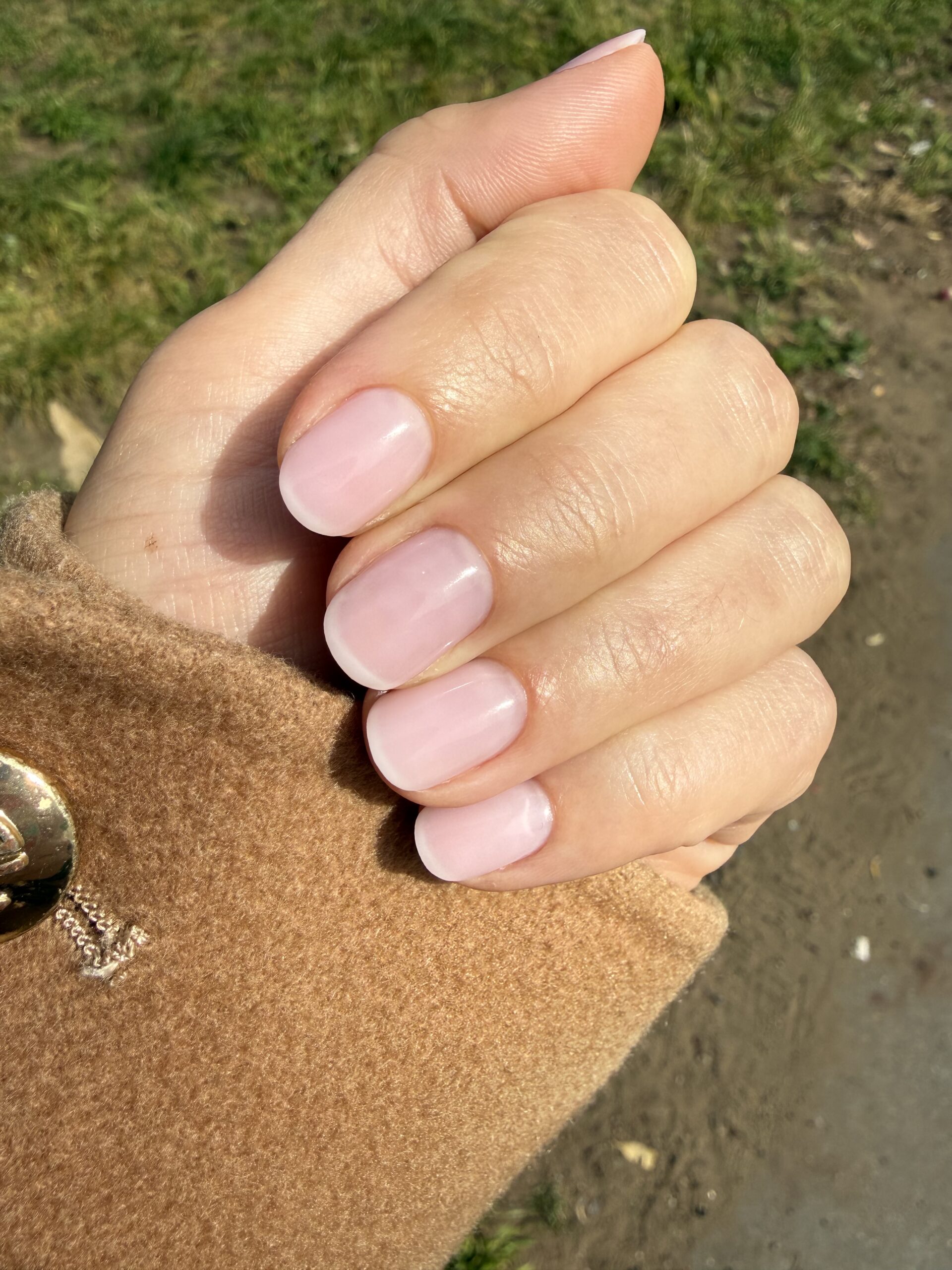 A close-up of a fresh "hidden French" Russian manicure SF with flawless cuticle work by Sabrine at NailDar.