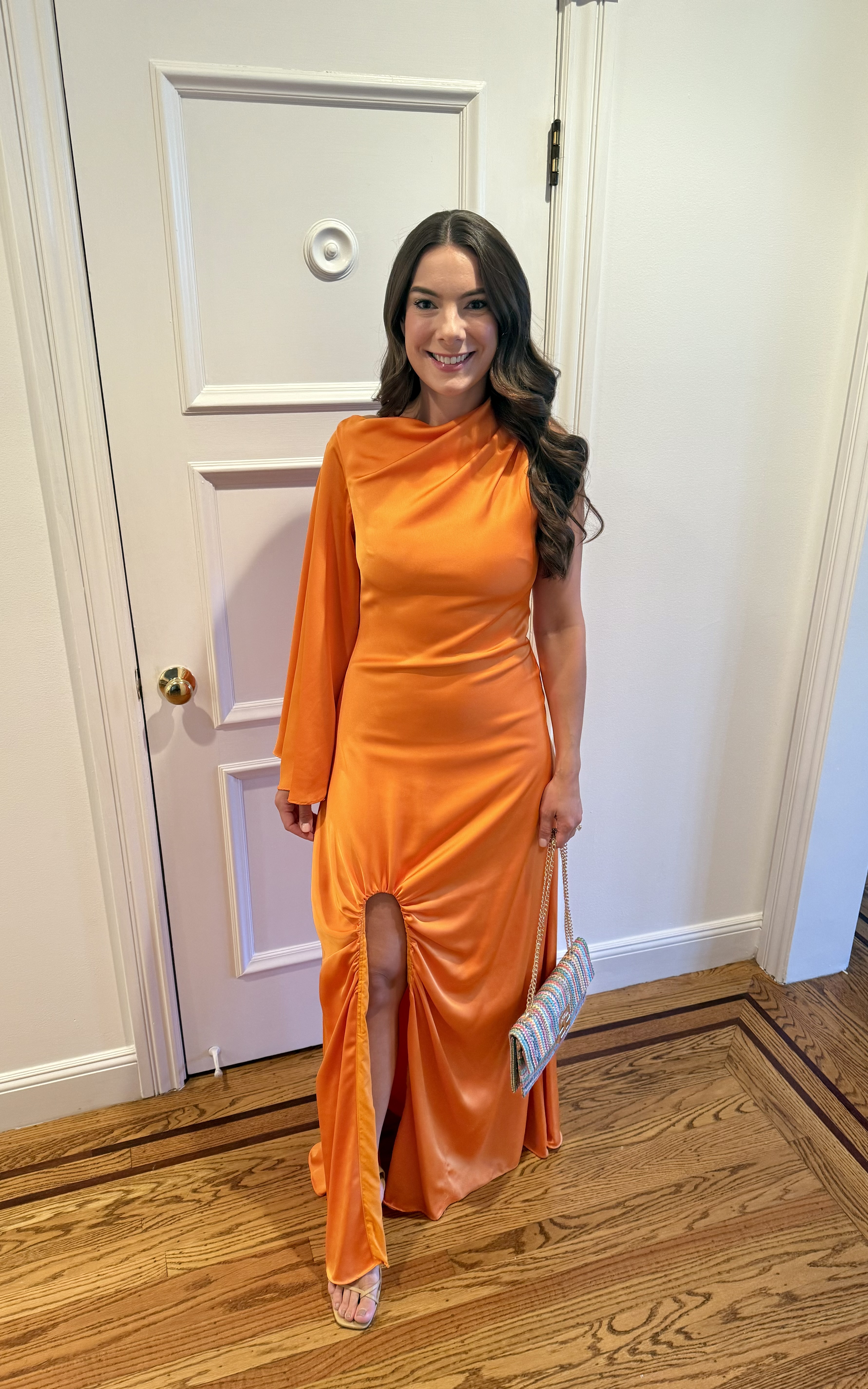 woman in orange Halston dress