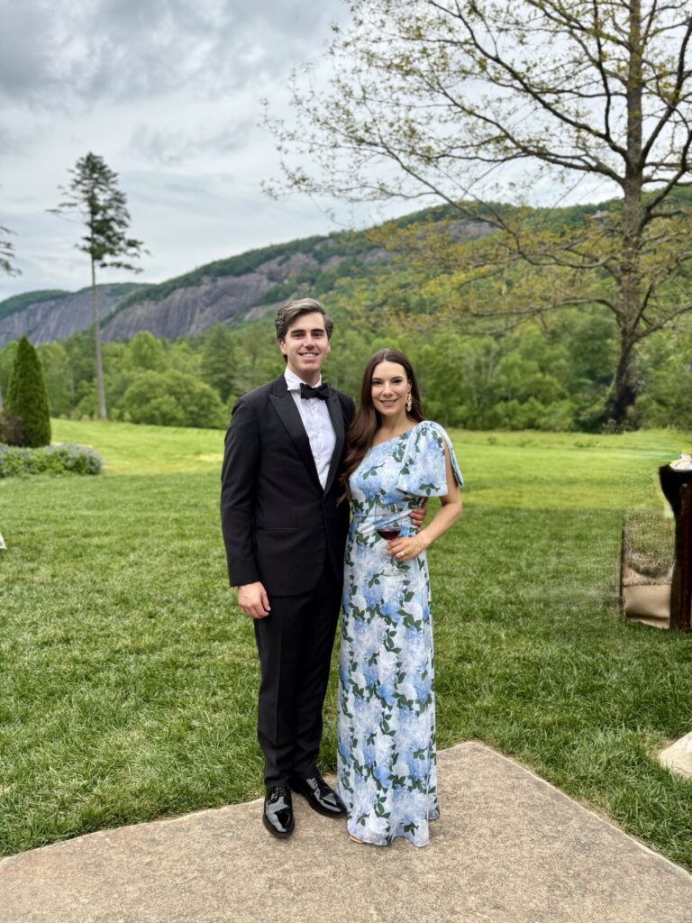 Couple at wedding, the woman is wearing a Sachin & Babi dress