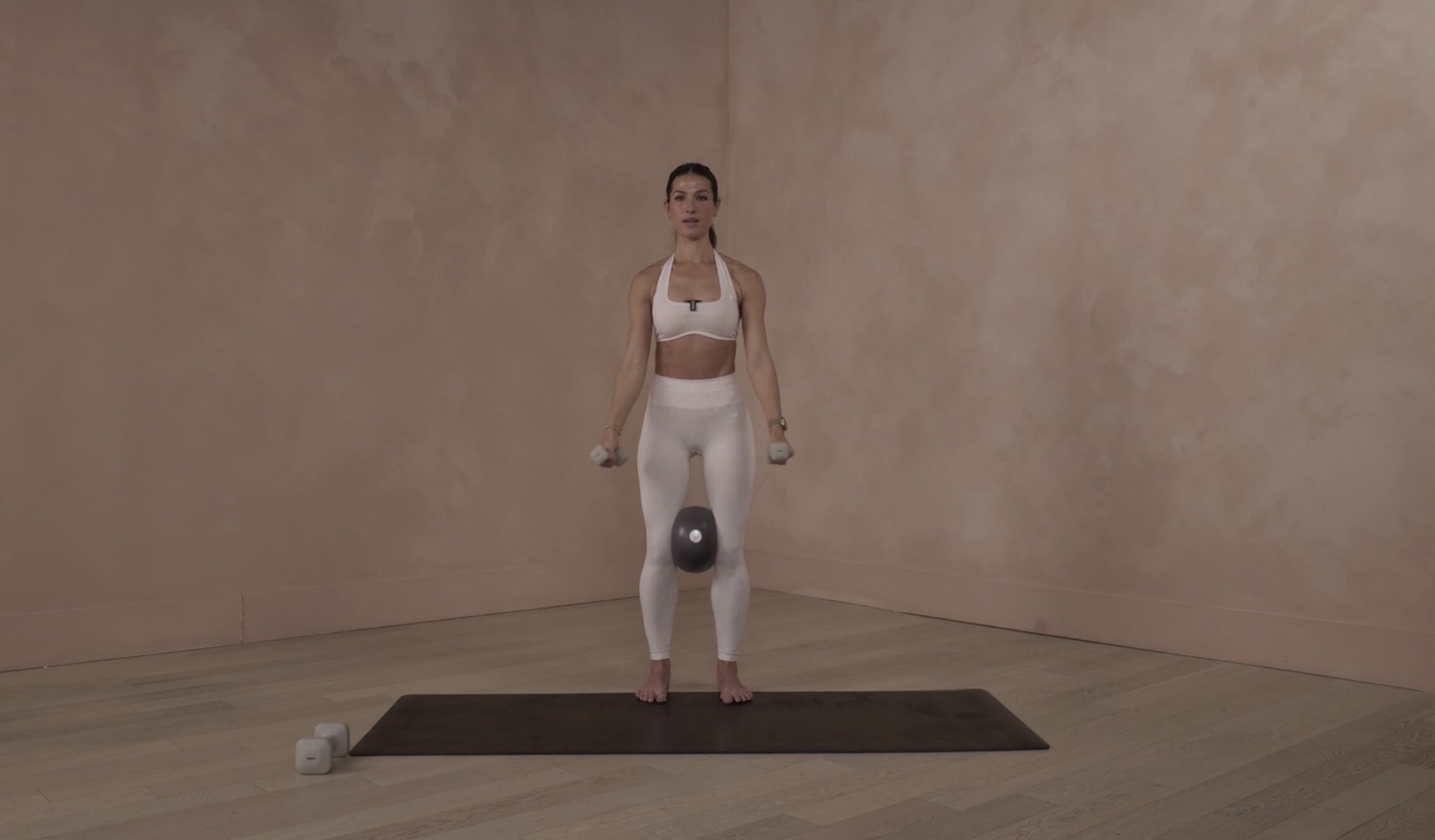 Lia Bartha demonstrating a form-focused Pilates movement during a B The Method workout session.