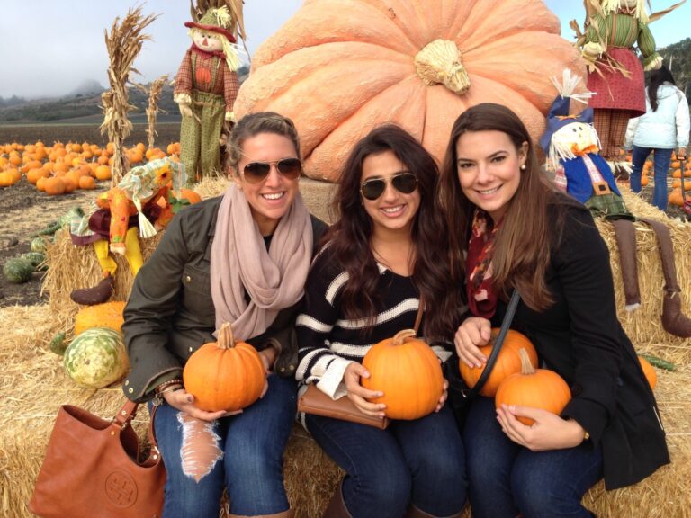 A San Francisco woman at a pumpkin patch laughing with friends, showing how to build community and make friends in SF.