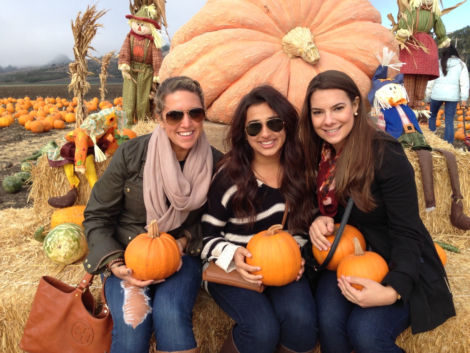 A San Francisco woman at a pumpkin patch laughing with friends, showing how to build community and make friends in SF.