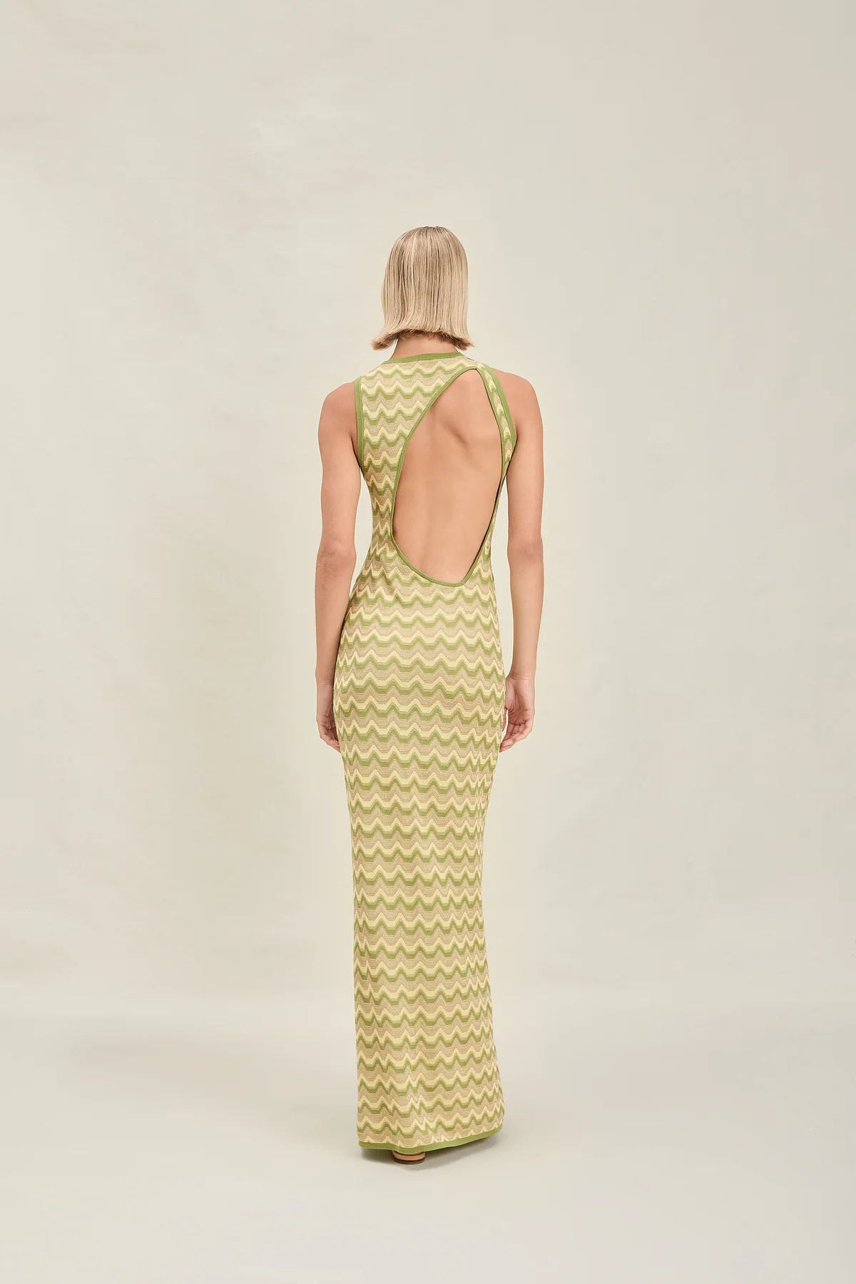 Woman in green chevron print dress with an open back similar to a Missoni design.