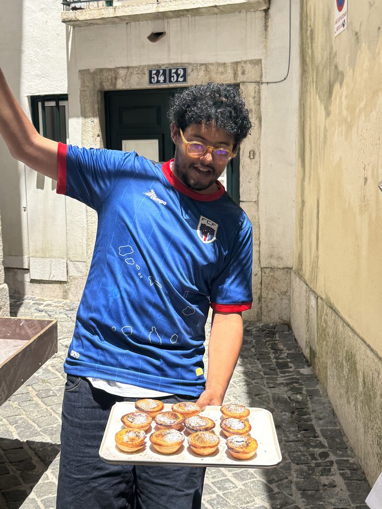 A local food tour guide in Lisbon holding a platter of traditional Portuguese custard tarts (pastéis de nata).
